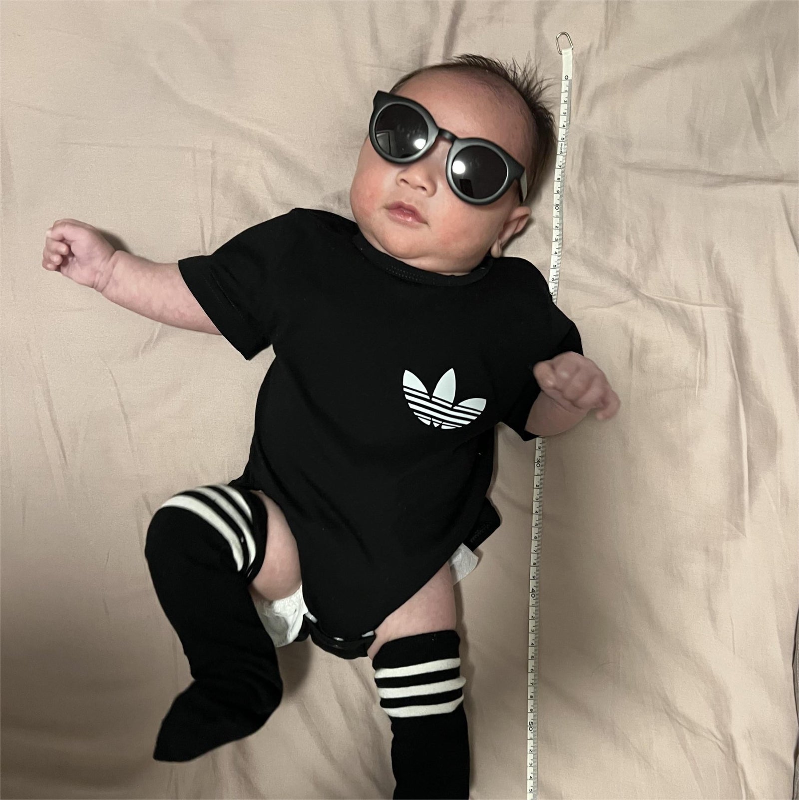 3-month-old baby wearing black bodysuit with sunglasses