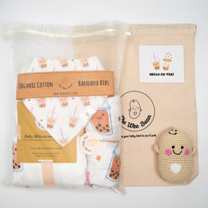 Baby product set with organic cotton bandana bibs and a plush toy, branded 'The Wee Bean'.