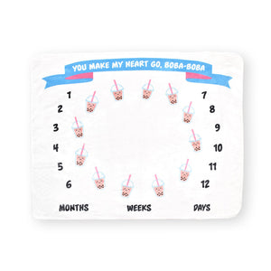 Baby milestone chart with boba design and text on a white background