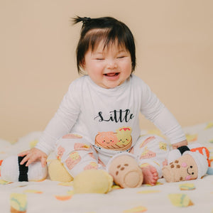 cute child laughing while playing with the wee bean dolls