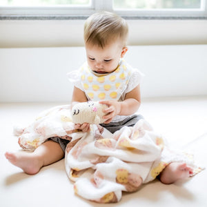 cute baby playing with the wee bean dim sum swaddle