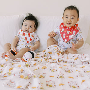 two cute babies in the wee bean organic cotton bandana bibs in lucky fortune cat