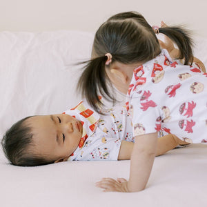 two cute babies wearing the wee bean organic cotton bib in milky candy and pocky