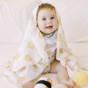 cute baby in the wee bean organic cotton cup noodle bib and swaddle