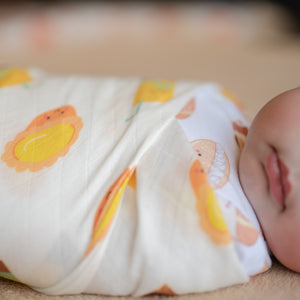 baby swaddled in the wee bean organic cotton and bamboo swaddle in vita lemon tea and egg tart close up