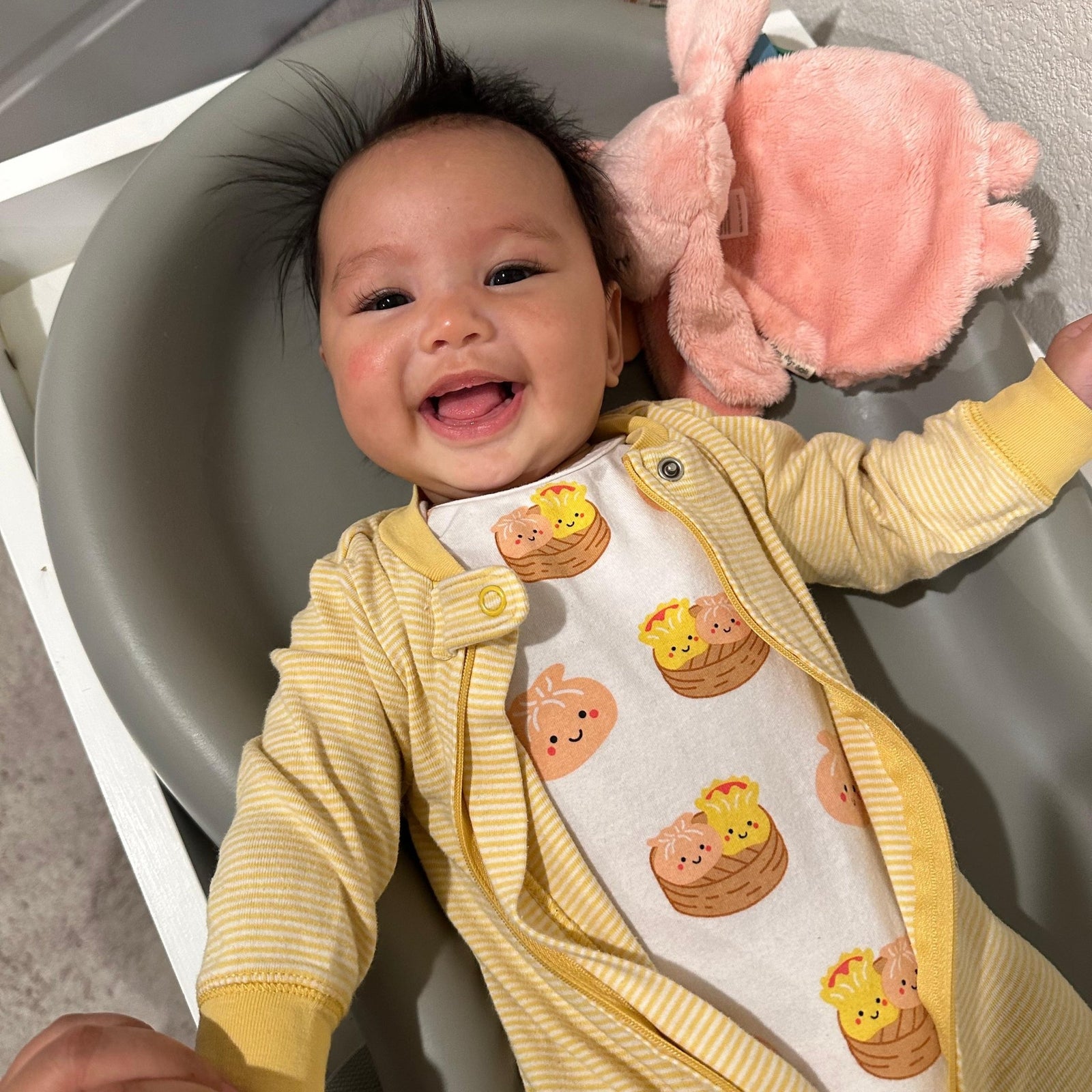 A smiling baby is wearing The Wee Bean's Dim Sum Onesie