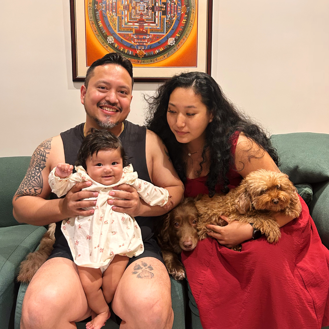 Father holding daughter and mother holding a doggie
