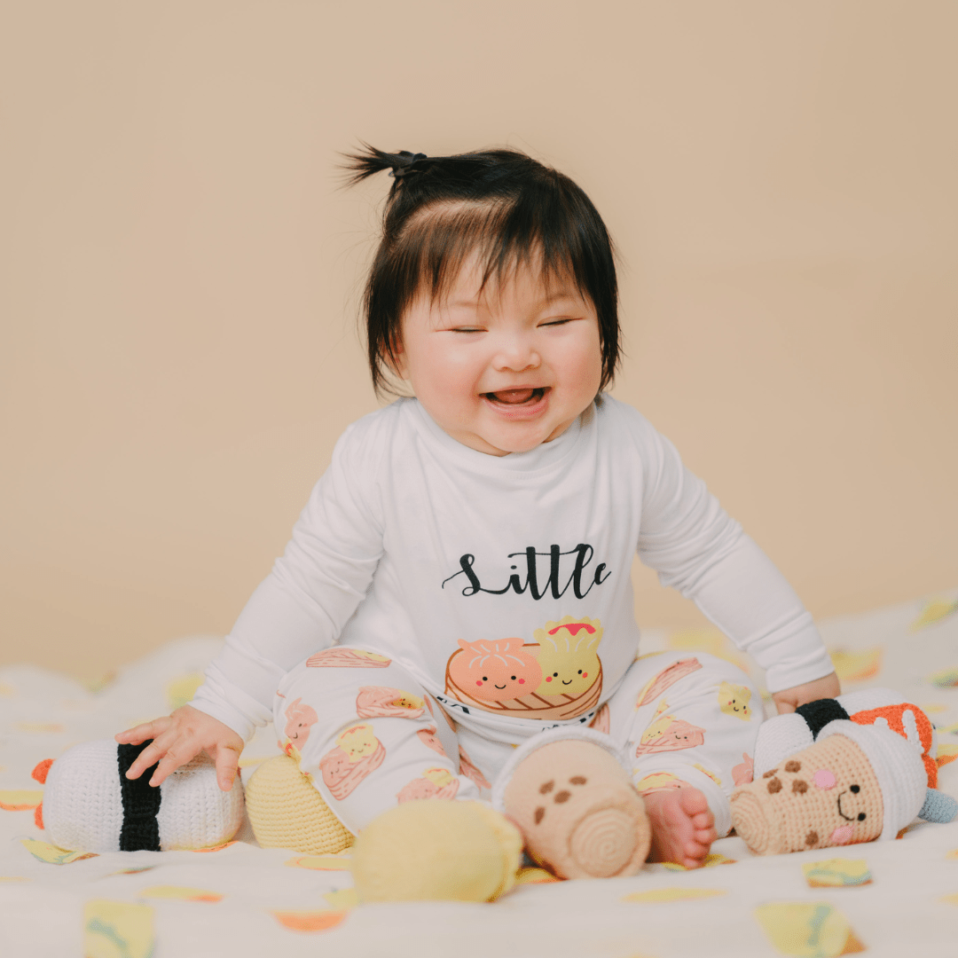 Girl baby with her rattle toys