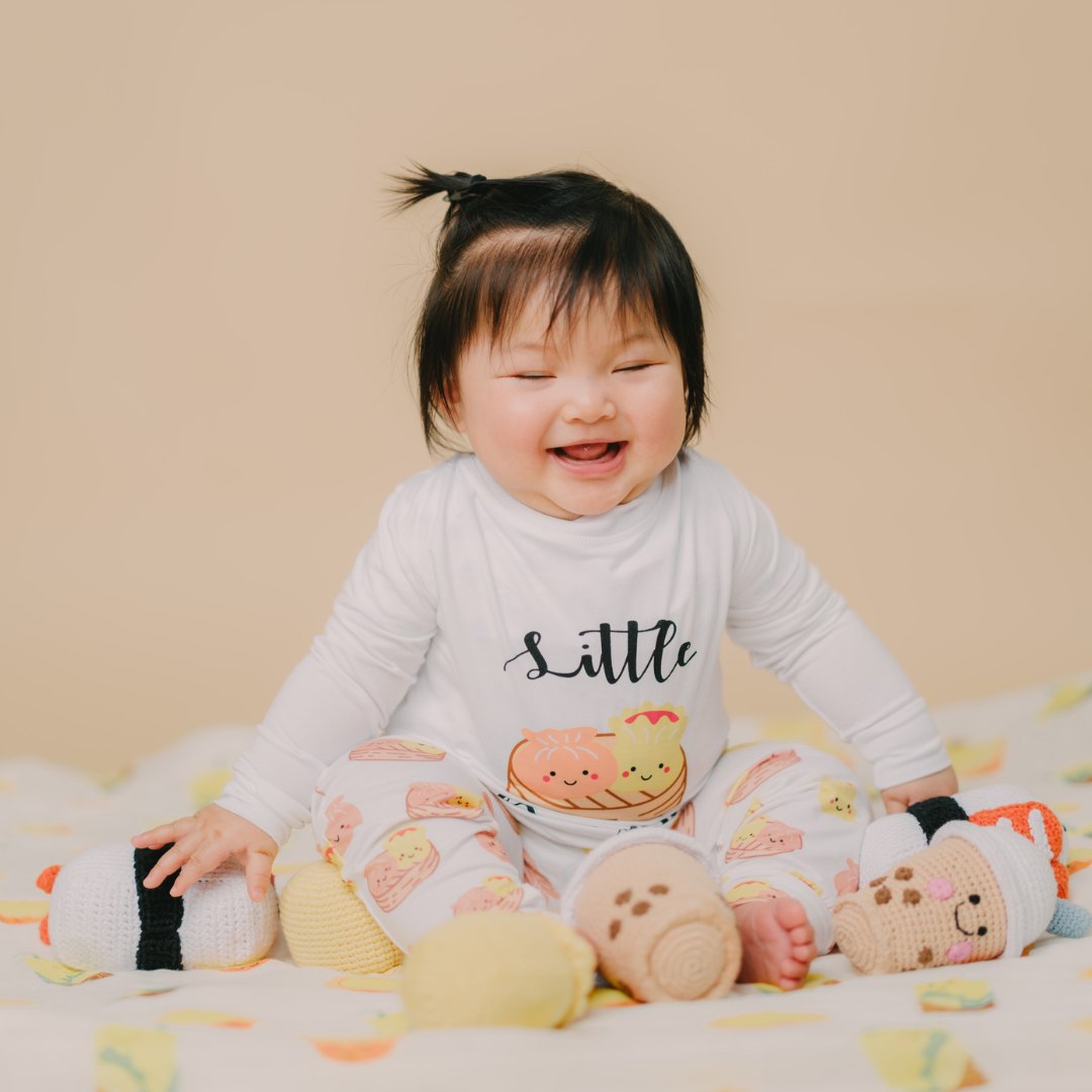 Girl baby with her rattle toys