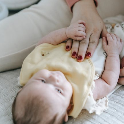 mom with baby on organic cotton clothing bedding