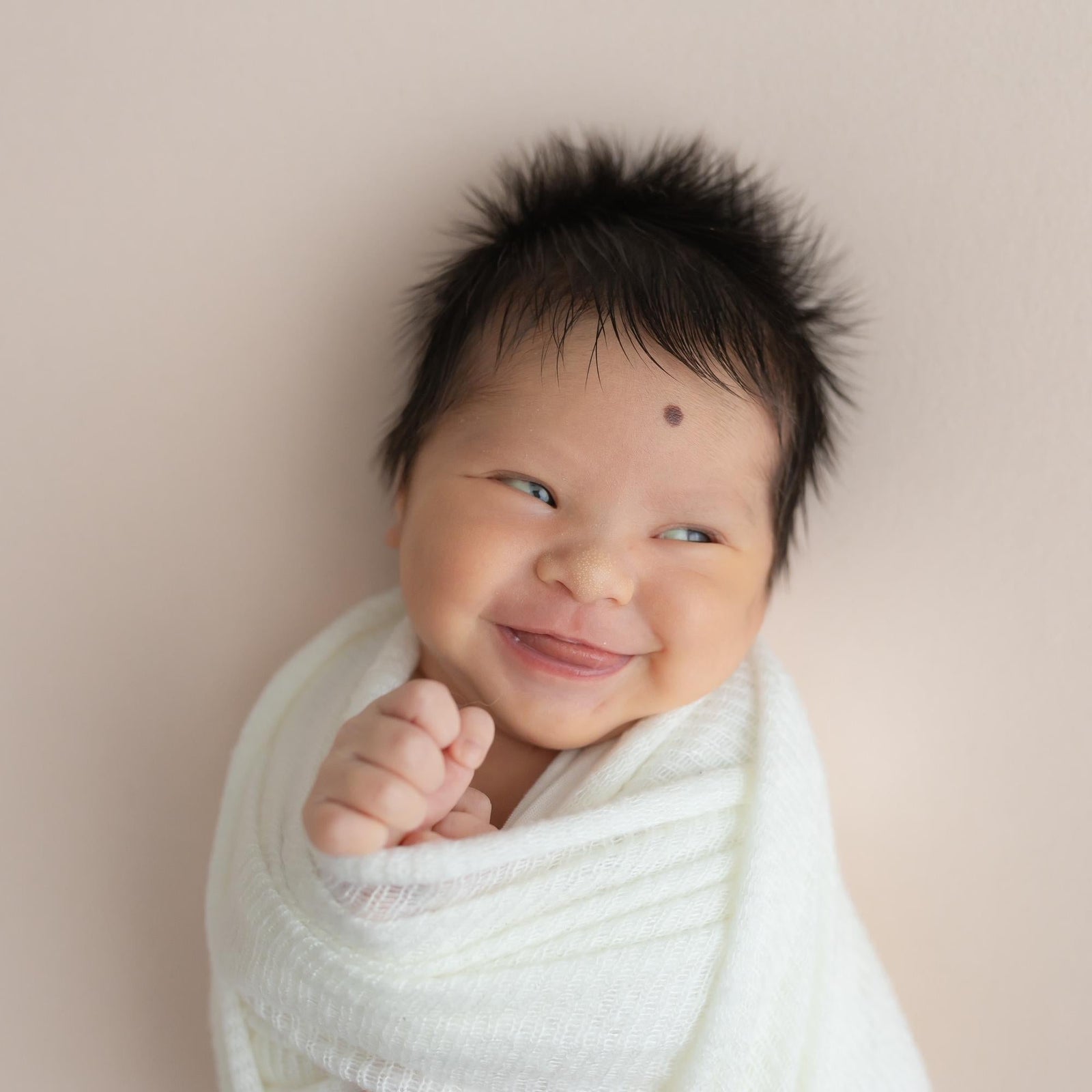 Newborn baby wrapped with swaddle