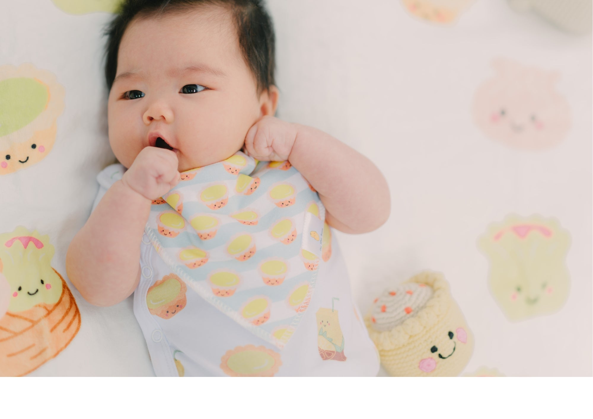 cute baby sucking thumb wearing the wee bean egg tart bib