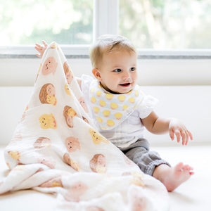 cute baby holding up the wee bean's dim sum organic bamboo cotton swaddle blanket