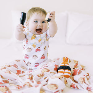cute baby playing with the wee bean organic cotton bamboo swaddles in takoyaki taste of japan