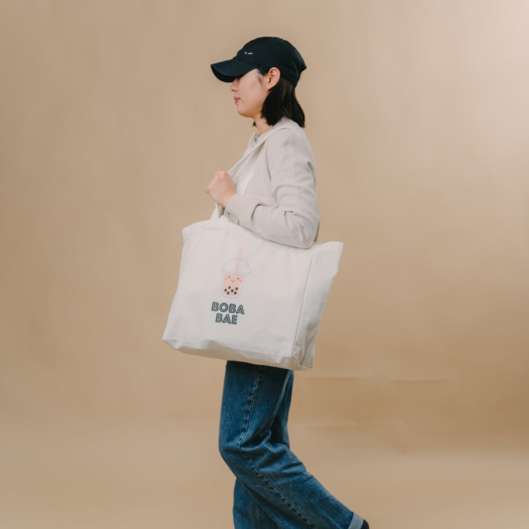 woman walking with the wee bean cotton canvas tote in boba bae