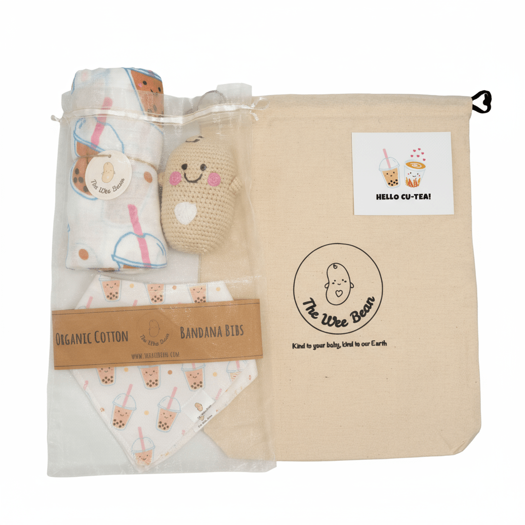 Baby product set with organic cotton bandana bibs, plush toy, and blanket in a branded bag.