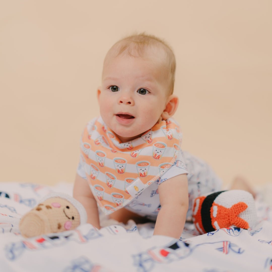 cute baby tummy time in milk tea bib