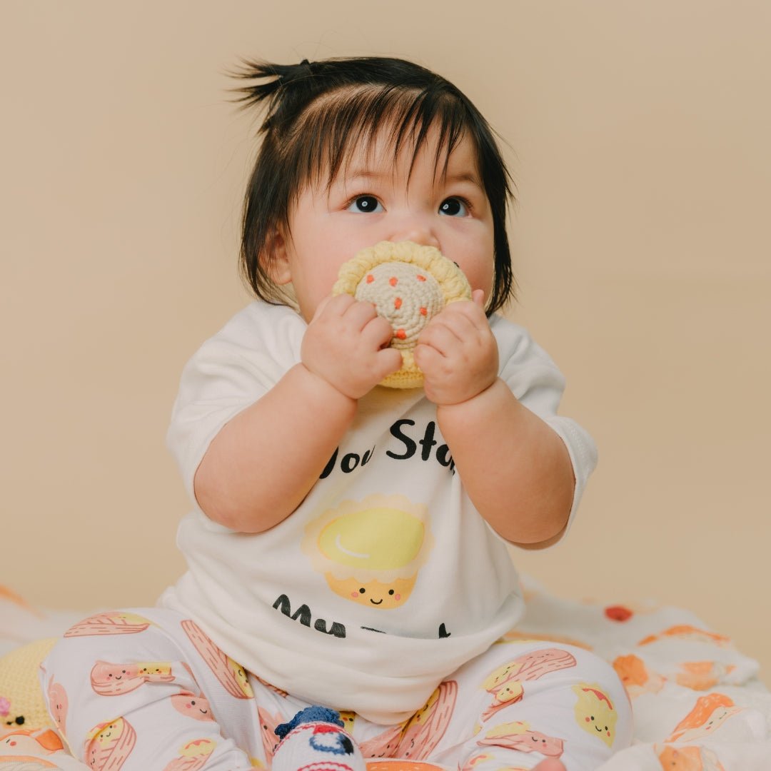 cute baby chewing on siu mai doll