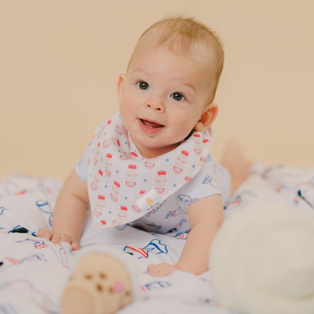 cute baby looking up in yogurt drink bib