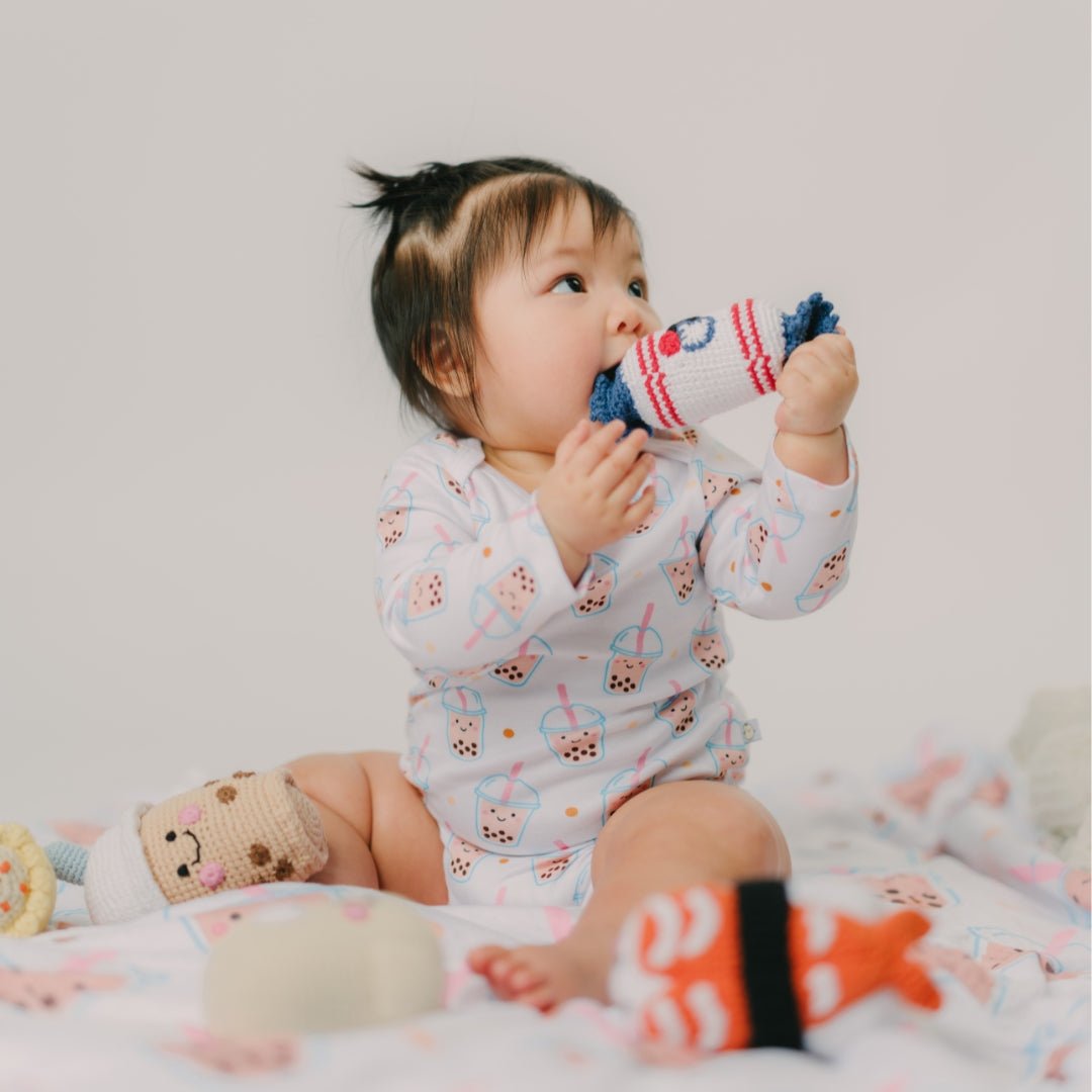 cute baby chewing on rabbit bunny candy rattle doll