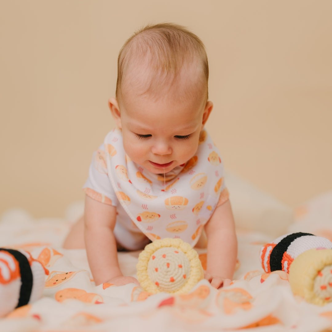cute baby drooling wearing the wee bean&#39;s bakery buns bib and onesie