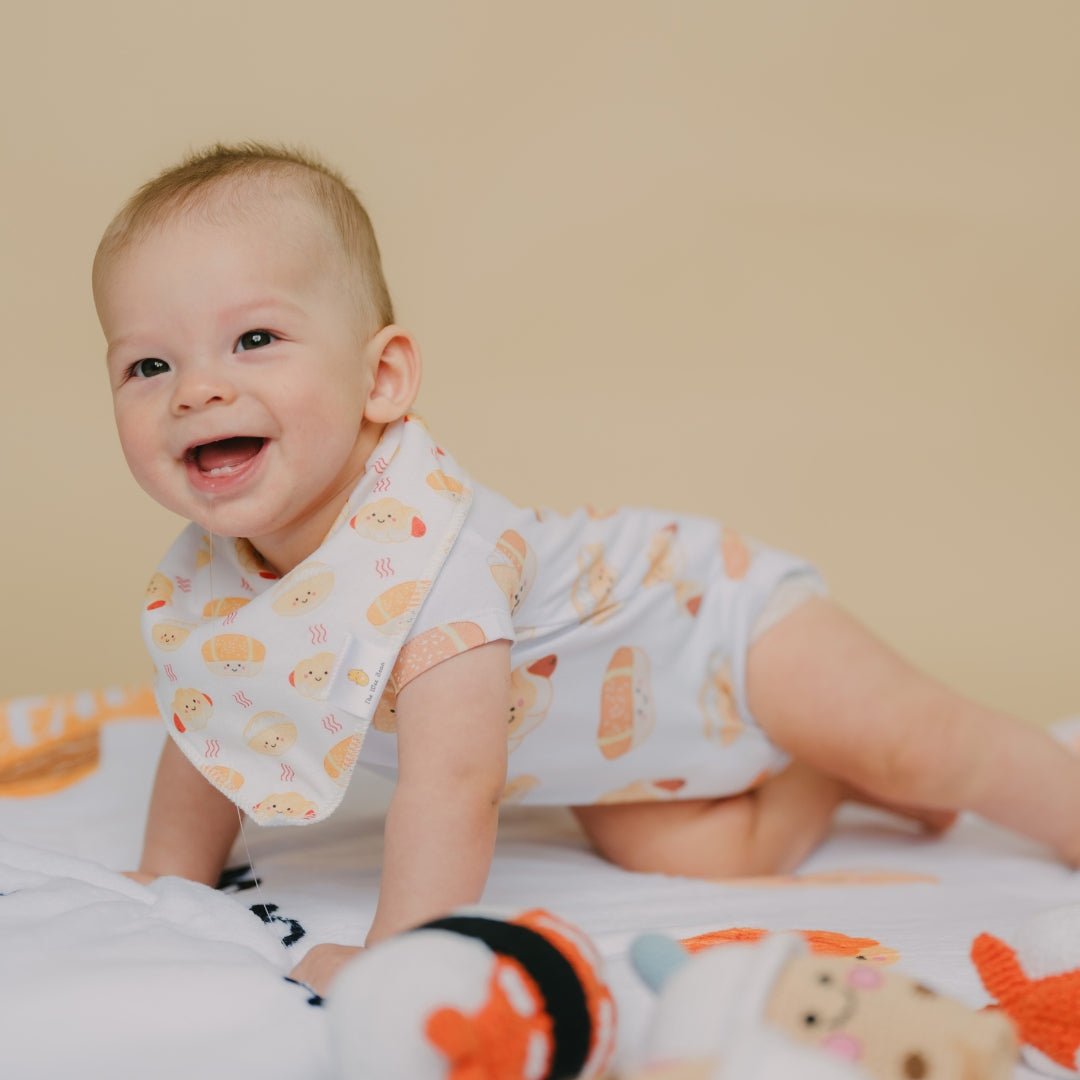 cute baby tummy time wearing the wee bean&#39;s bakery buns bib and onesie