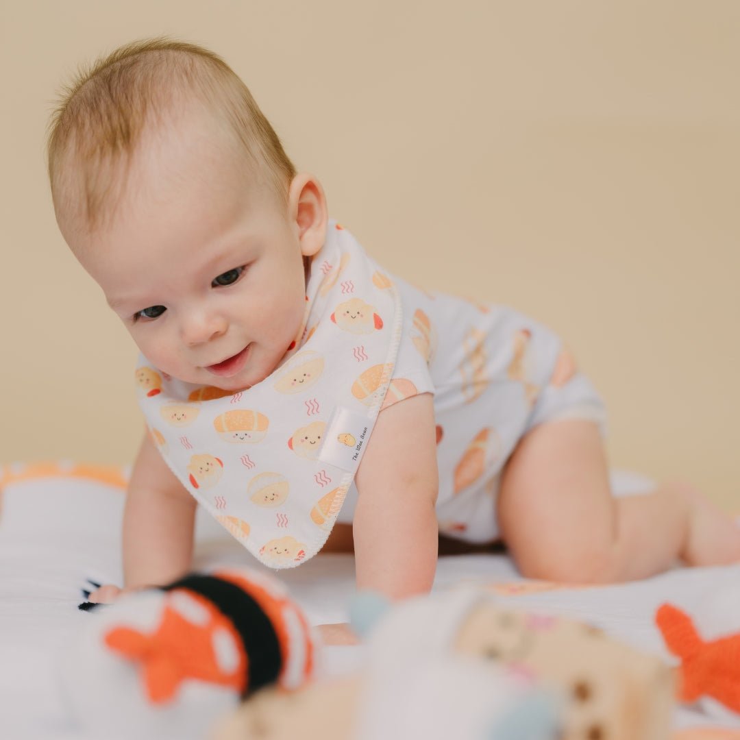 cute baby tummy time wearing the wee bean&#39;s bakery buns bib and onesie