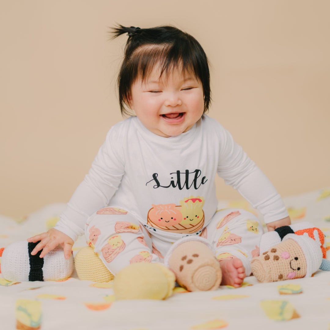 cute child laughing while playing with the wee bean dolls

