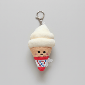 Plush ice cream cone keychain with a smiling face on a light gray background