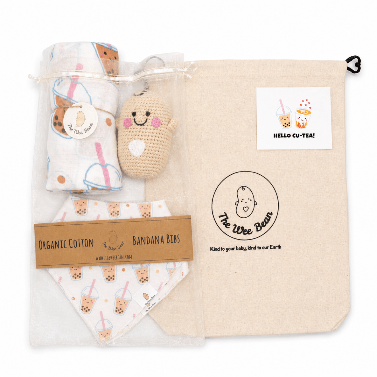 Baby product set with organic cotton bandana bibs, plush toy, and blanket in a branded bag.