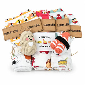 Packaged organic cotton bandana bibs with a plush toy and card, featuring sushi-themed designs.