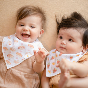 two babies wearing the wee bean organic cotton bib set in bakery buns and egg sandwich and iced tea cha chaan teng