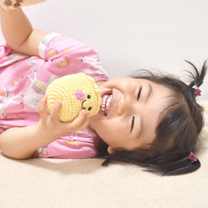 little girl playing with the wee bean fair-trade doll in siu mai dim sum