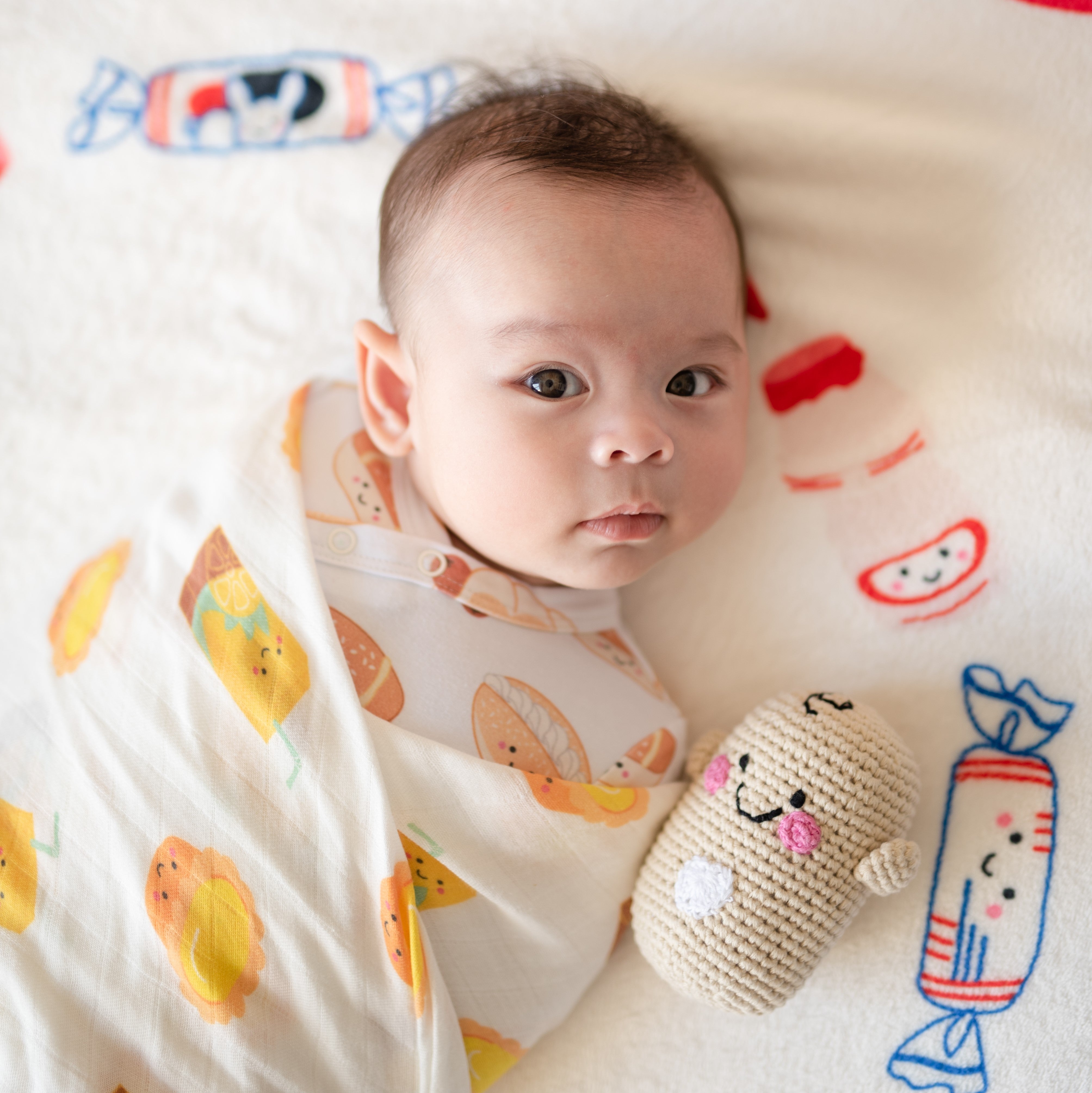 newborn baby on milestone blanket with the wee bean rattle doll fair-trade dolls pebblechild
