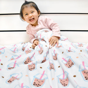 baby toddler wrapped in boba fleece blanket