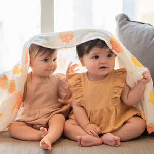 cute babies playing peekaboo in the wee bean iced gem biscuit belly button cookies organic cotton bamboo swaddle