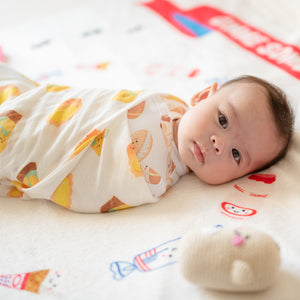 cute baby swaddled in the wee bean organic bamboo swaddle in vita lemon tea and egg tart