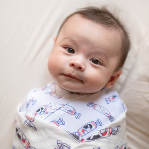 cute baby swaddled wearing the wee bean organic cotton onesie romper bodysuit in white rabbit candy