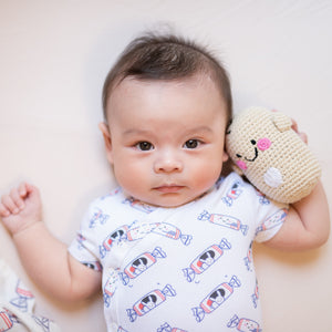 cute baby big eye holding bean doll in the wee bean organic cotton onesies clothing romper in white rabbit candy