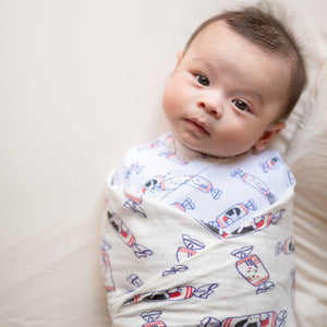 cute baby swaddled in the wee bean organic cotton bamboo super soft swaddle in white rabbit candy
