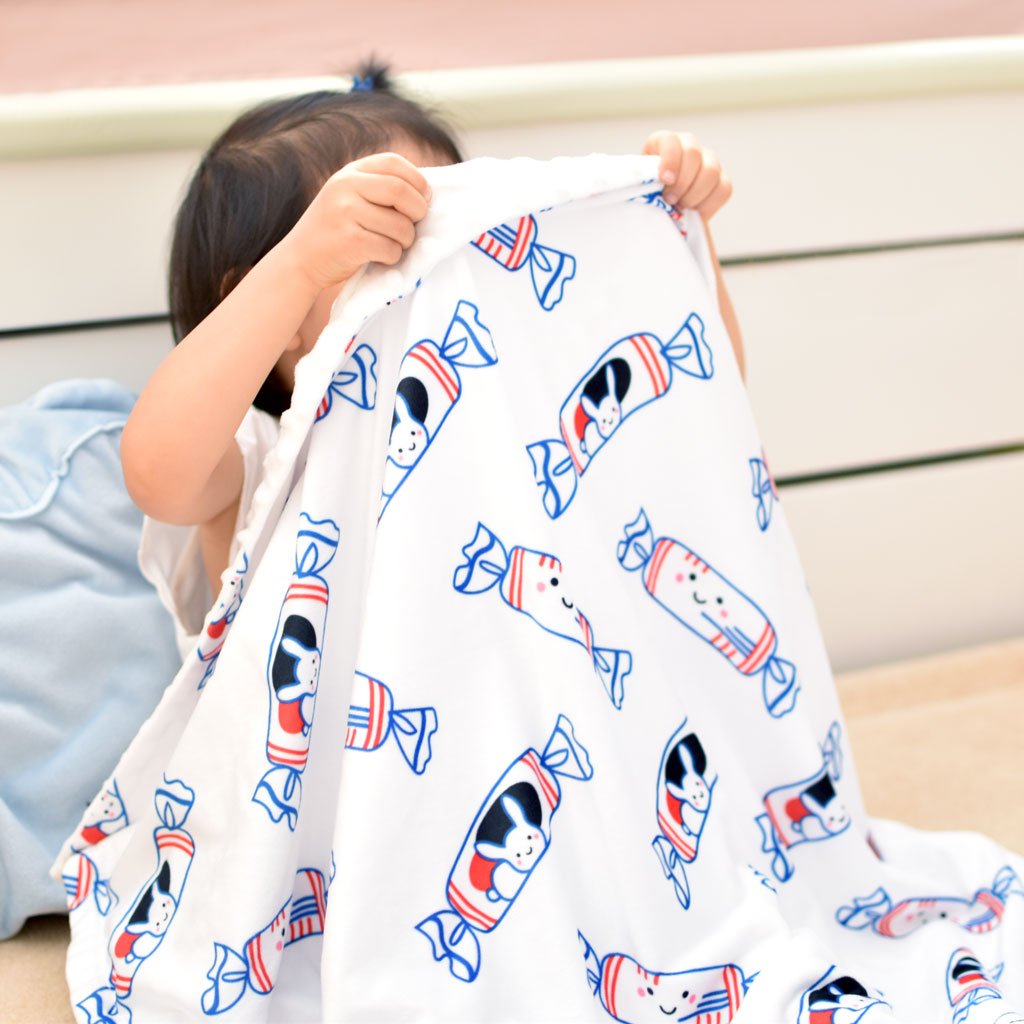 child holding up blanket the wee bean super soft minky fleece baby blanket with white rabbit candy 