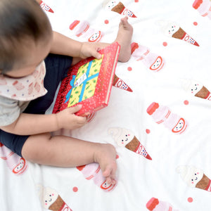 baby reading a book on the wee bean super soft baby minky fleece blanket with yakult mr softee ice cream print