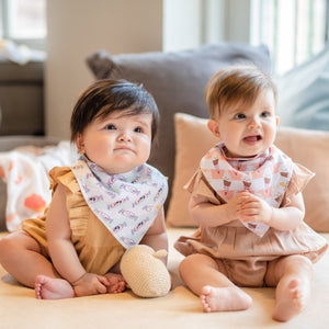 cute babies playing together wearing the wee bean organic cotton bandana bib in white rabbit candy and mr softee ice cream