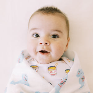 close up cute baby in the wee bean organic cotton onesie bodysuit in cup noodle