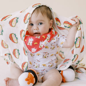 the wee bean baby playing with organic cotton and bamboo swaddle in japanese ramen noodle
