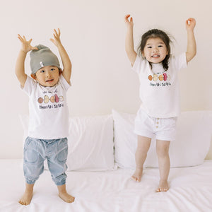 two cute kids in the wee bean organic cotton toddler kids tee t-shirt in we are all human beans