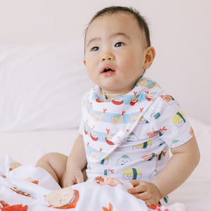 cute baby in the wee bean organic cotton drool bib in shrimp tempura