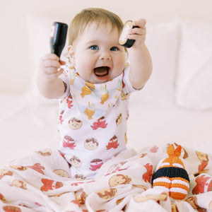 cute baby playing in the wee bean takoyaki onesie and taiyaki bib