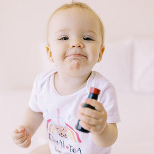 smiling baby in the wee bean organic cotton onesie bodysuit romper in equality equalitea