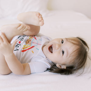 smiling baby in the wee bean organic cotton onesie bodysuit romper in boba equality equalitea